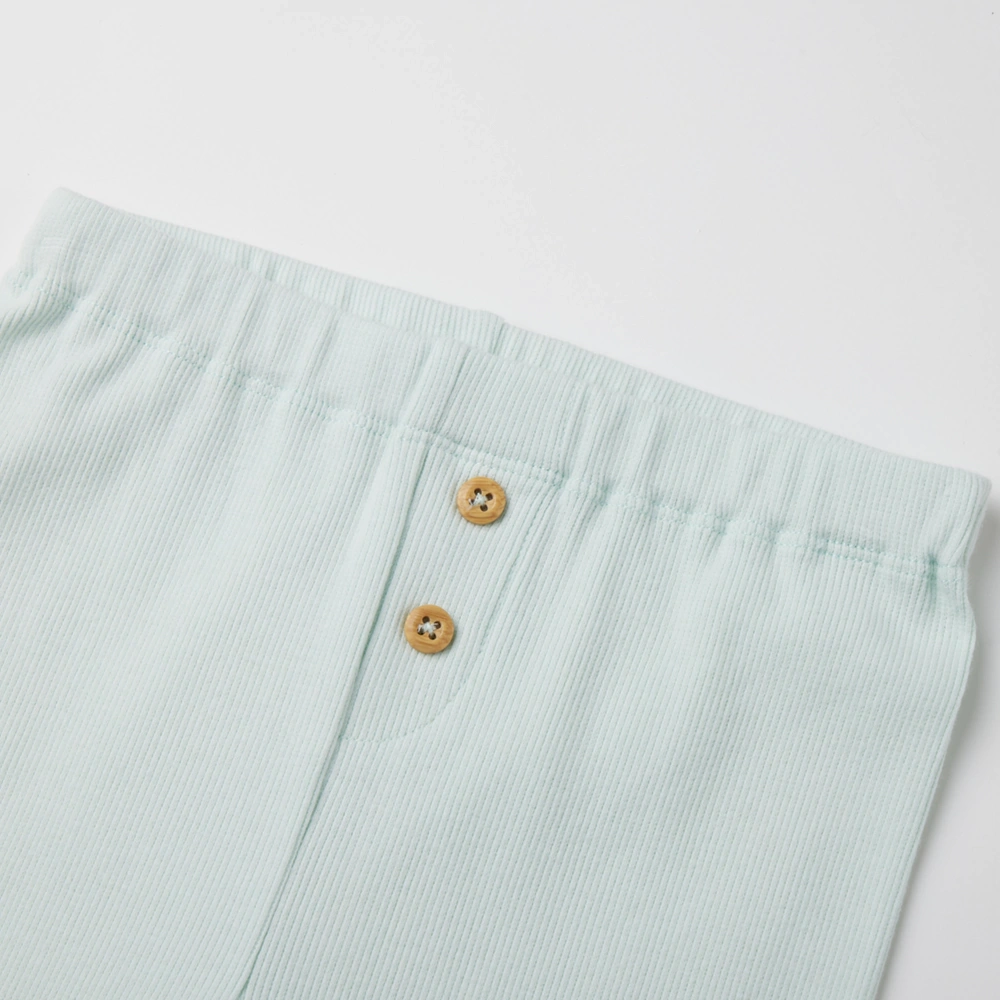 Baby girl long sleeve ribbed button-up top and pants set made from organic cotton with natural plant dyes