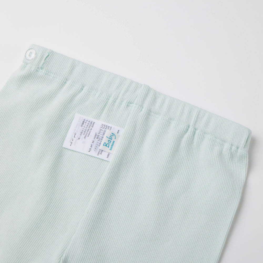 Baby girl long sleeve ribbed button-up top and pants set made from organic cotton with natural plant dyes