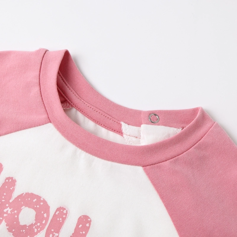 Close-up of the smooth crew neckline and securely closed raglan seam shoulder snaps on the organic baby onesie.