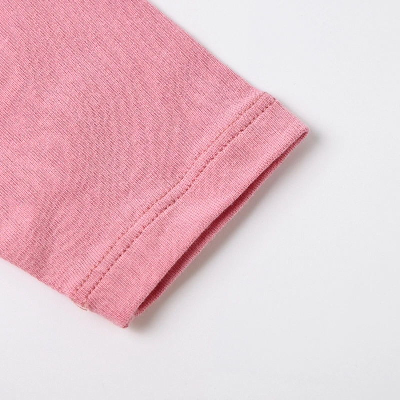 Detail of the natural strawberry pink long sleeve cuff featuring neat, high-resilience double-stitched seams.