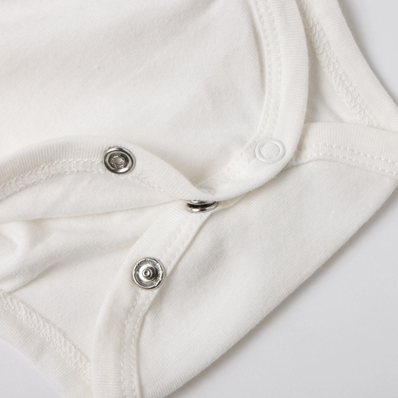 Bottom view showcasing the securely fastened continuous crotch snaps for quick diaper access on the organic bodysuit.