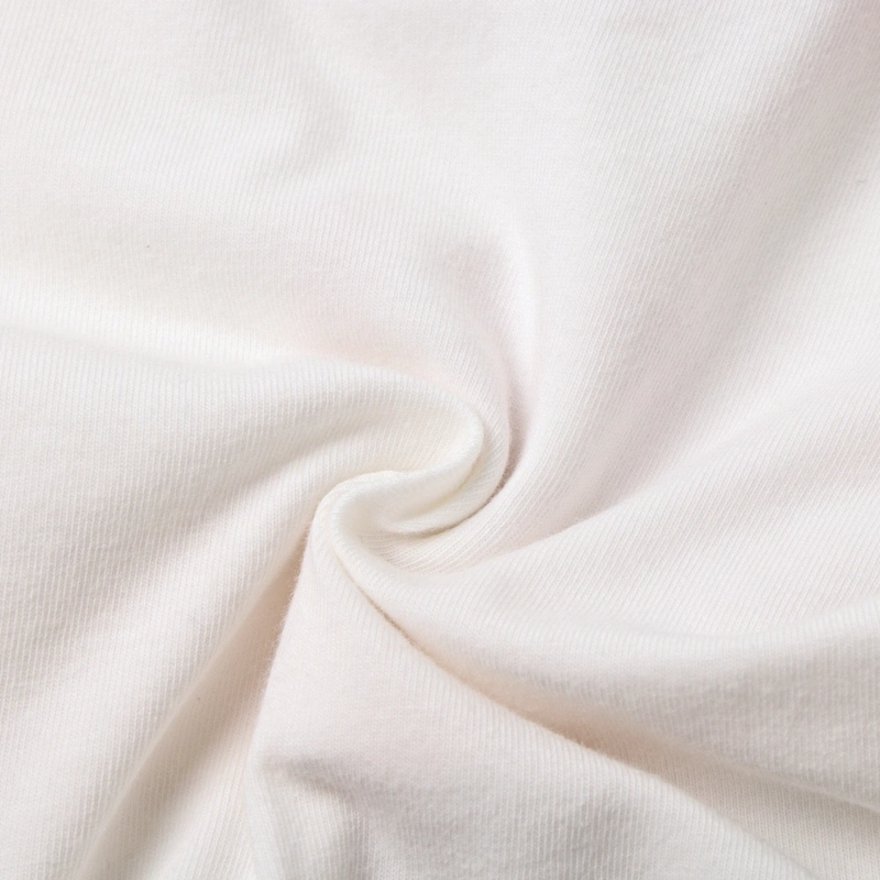 Soft swirl macro shot of the GOTS-certified organic cotton interlock fabric highlighting its smooth, breathable texture.