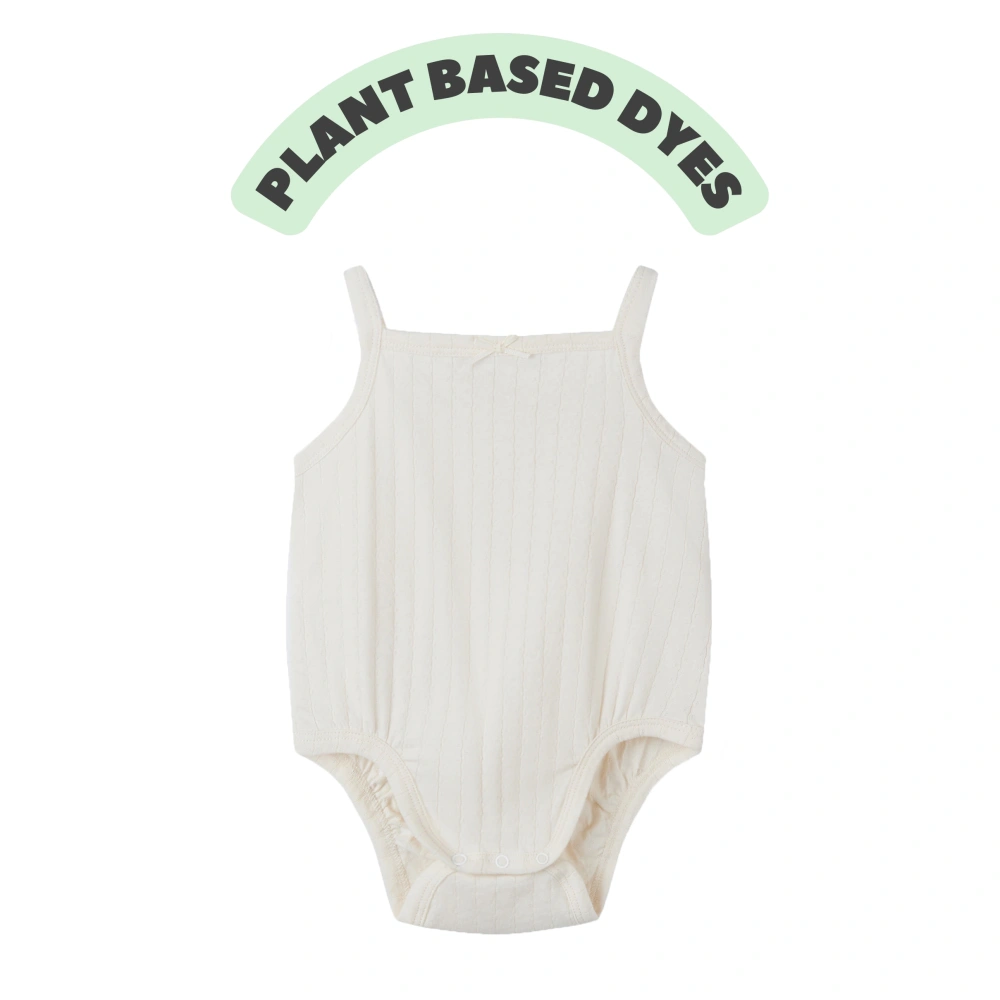 Baby girl wearing Senseng organic cotton pointelle strappy bodysuit, plant-dyed, breathable and eco-friendly