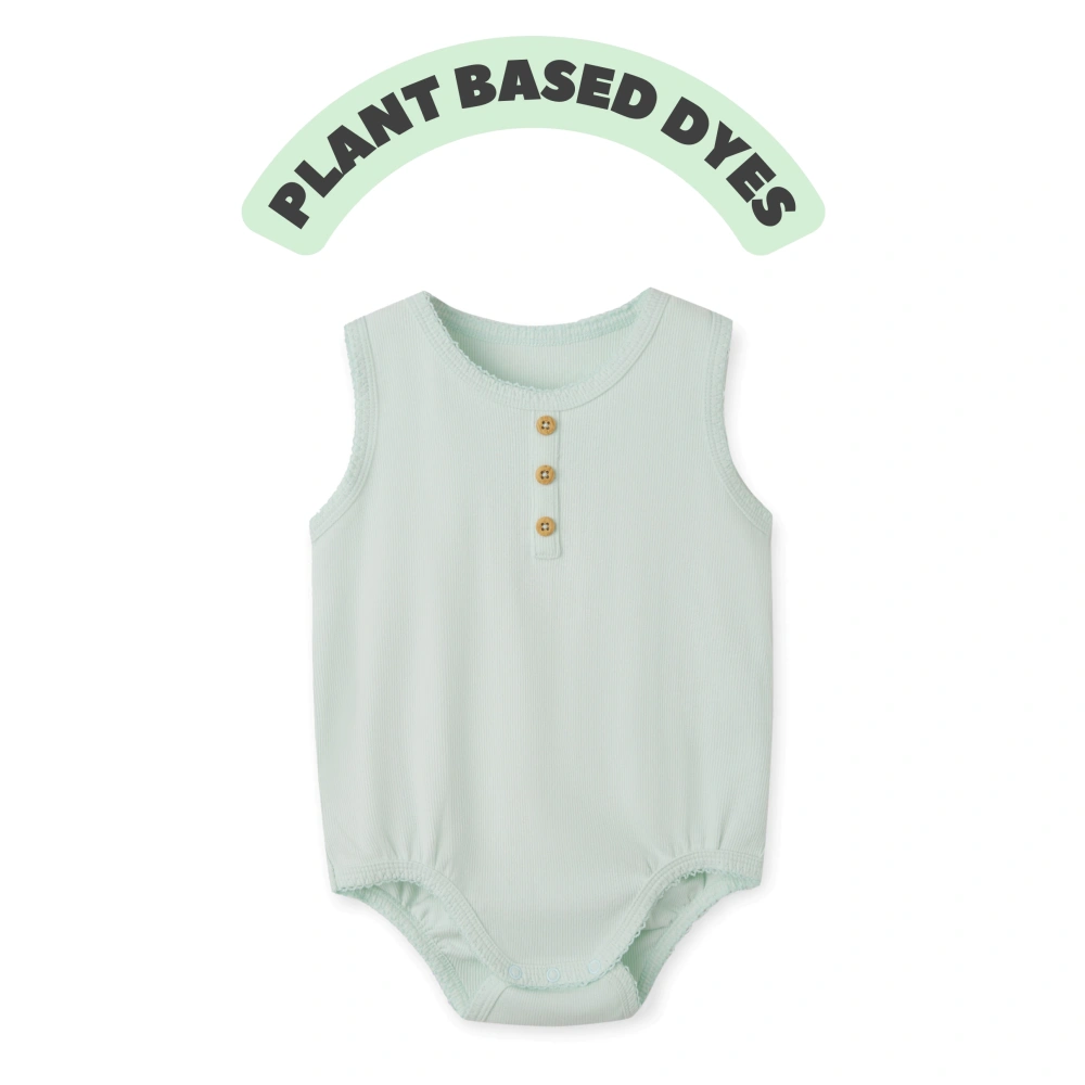 Baby girl wearing plant-dyed organic-cotton sleeveless bodysuit with snap crotch and soft bindings