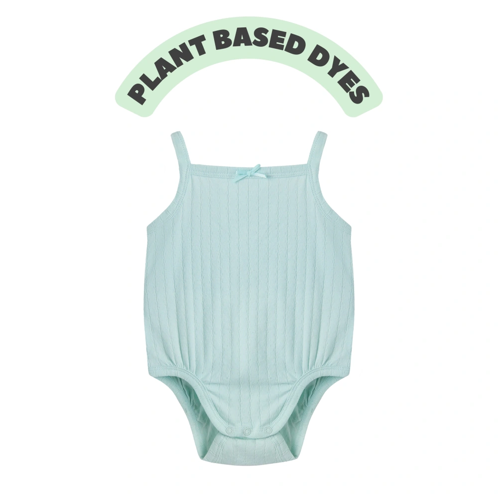 Baby girl wearing Senseng organic cotton pointelle strappy bodysuit, plant-dyed, breathable and eco-friendly