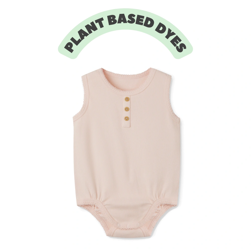 Baby girl wearing plant-dyed organic-cotton sleeveless bodysuit with snap crotch and soft bindings