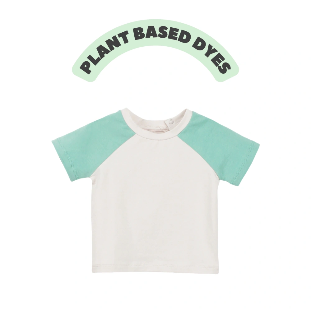 Front view of SENSENG unisex baby Leo raglan short sleeve tee in plant-dyed botanical natural powder puff/gree colorway, showcasing sporty contrast shoulder layout.