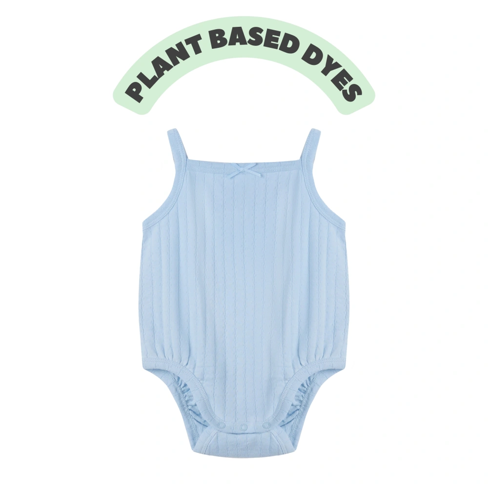 Baby girl wearing Senseng organic cotton pointelle strappy bodysuit, plant-dyed, breathable and eco-friendly