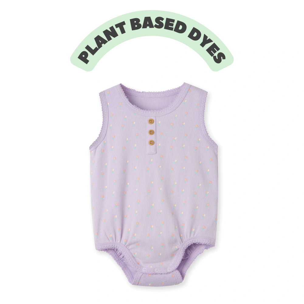 Baby girl wearing plant-dyed organic-cotton sleeveless bodysuit with snap crotch and soft bindings
