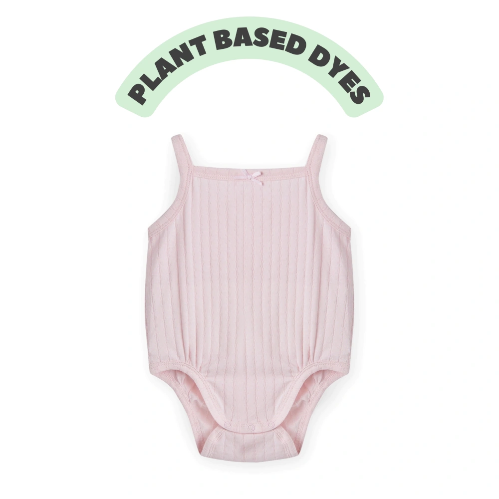 Baby girl wearing Senseng organic cotton pointelle strappy bodysuit, plant-dyed, breathable and eco-friendly