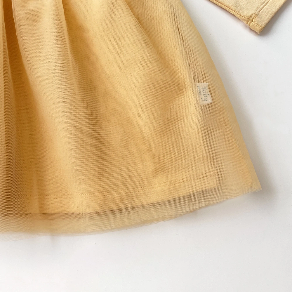 Baby girl wearing French terry long sleeve organic cotton dress with plant-dyed fabric