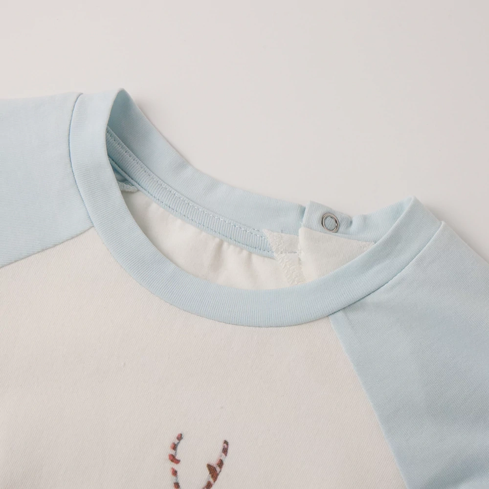 Close-up of nickel-free snaps on plant-dyed baby bodysuit