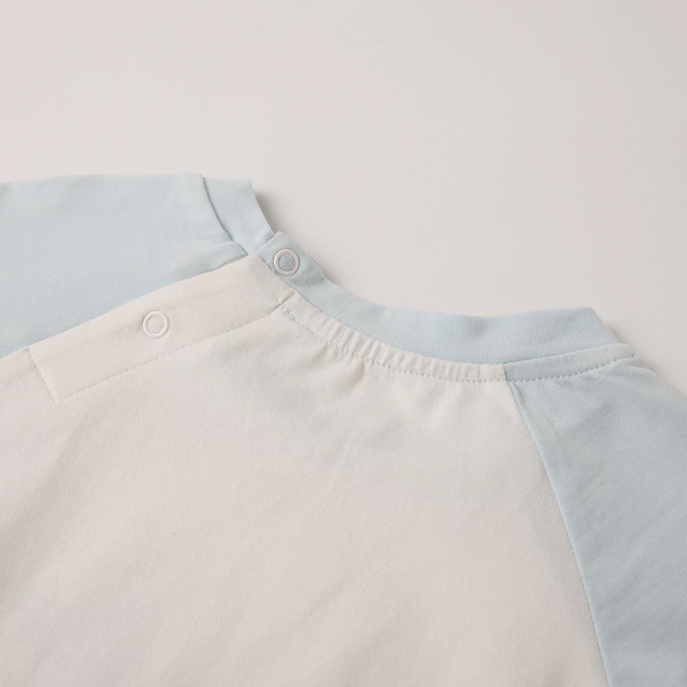 Close-up of nickel-free snaps on plant-dyed baby bodysuit