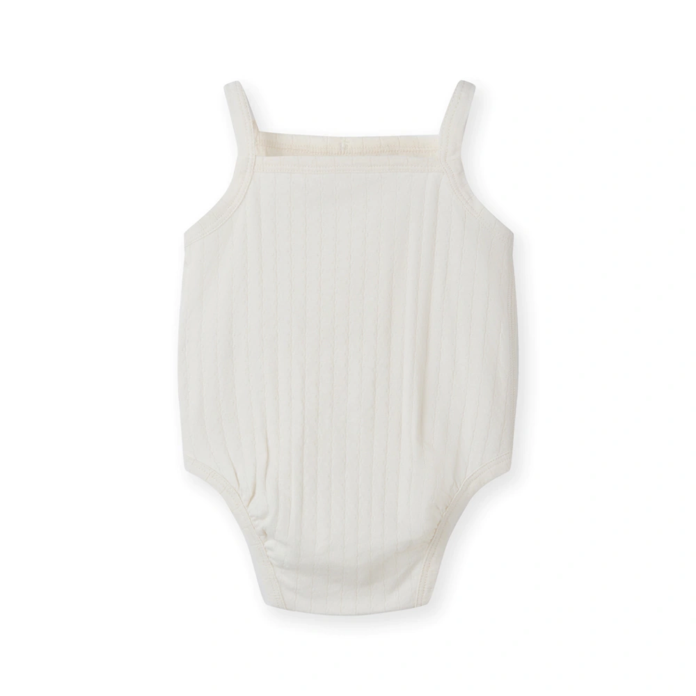 Baby girl wearing Senseng organic cotton pointelle strappy bodysuit, plant-dyed, breathable and eco-friendly