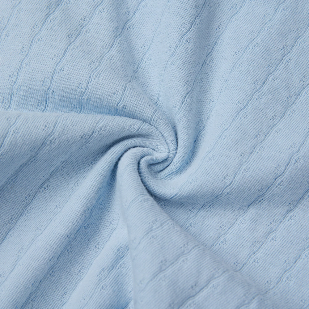 Baby girl wearing Senseng organic cotton pointelle strappy bodysuit, plant-dyed, breathable and eco-friendly