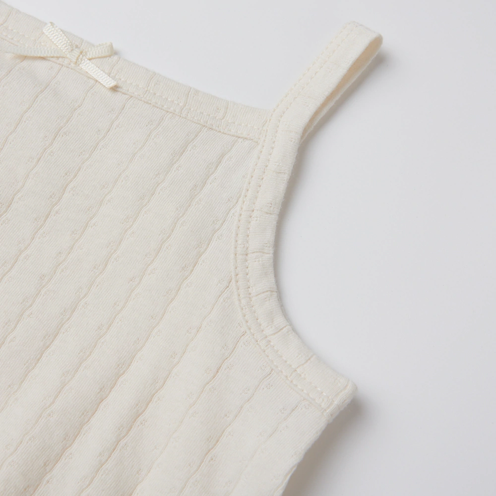 Baby girl wearing Senseng organic cotton pointelle strappy bodysuit, plant-dyed, breathable and eco-friendly