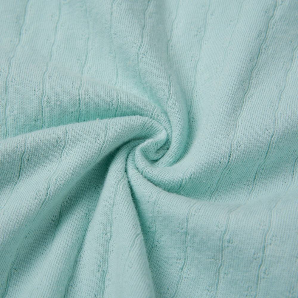 Baby girl wearing Senseng organic cotton pointelle strappy bodysuit, plant-dyed, breathable and eco-friendly