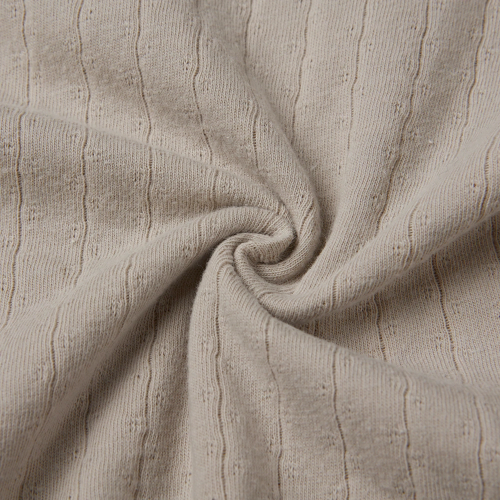 Pointelle sleeveless organic cotton baby bodysuit with plant-based dyes, eco-friendly design for infants 0-18 months