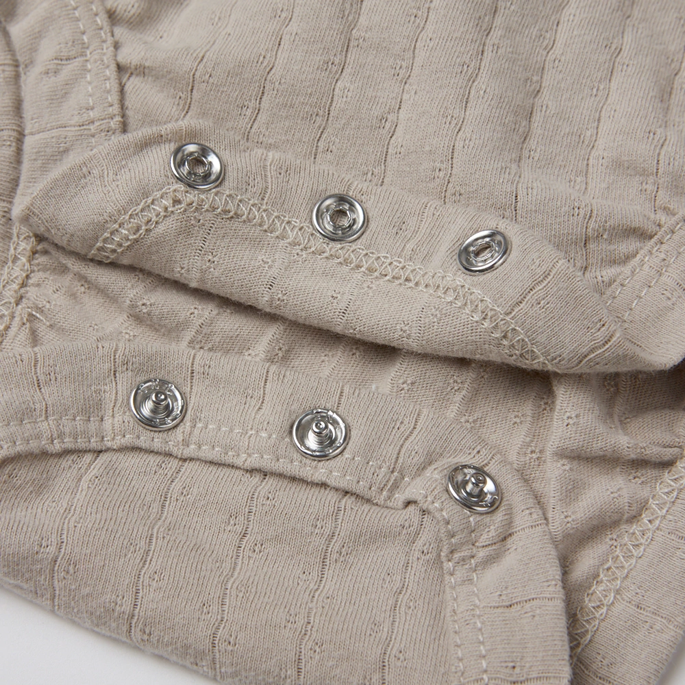 Pointelle sleeveless organic cotton baby bodysuit with plant-based dyes, eco-friendly design for infants 0-18 months