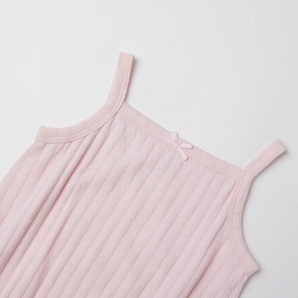 Baby girl wearing Senseng organic cotton pointelle strappy bodysuit, plant-dyed, breathable and eco-friendly