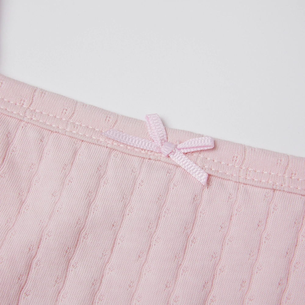 Baby girl wearing Senseng organic cotton pointelle strappy bodysuit, plant-dyed, breathable and eco-friendly