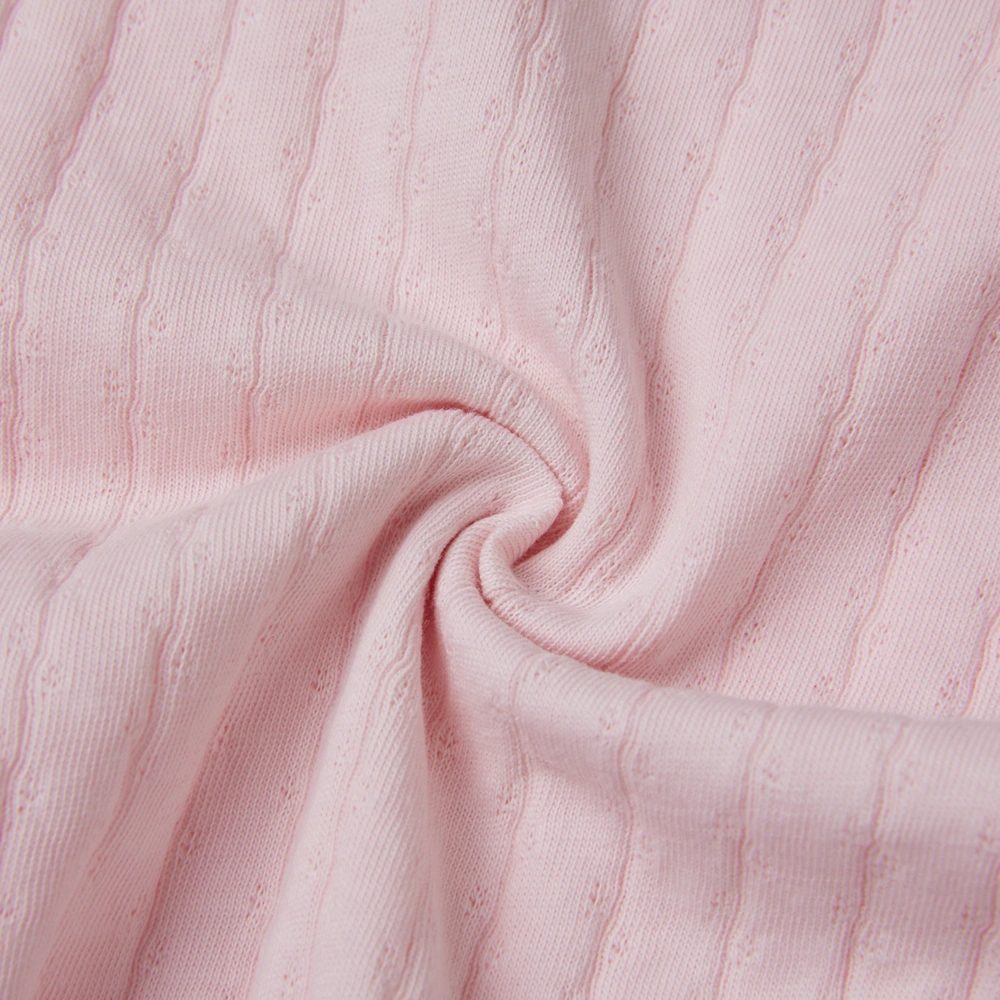 Baby girl wearing Senseng organic cotton pointelle strappy bodysuit, plant-dyed, breathable and eco-friendly