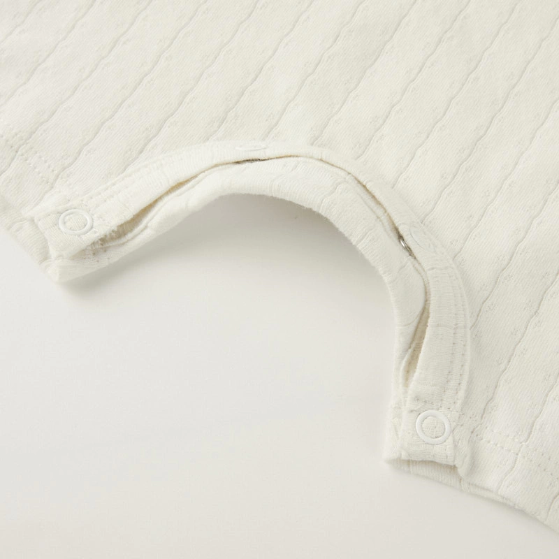 Baby wearing organic cotton plant-dyed unisex romper

