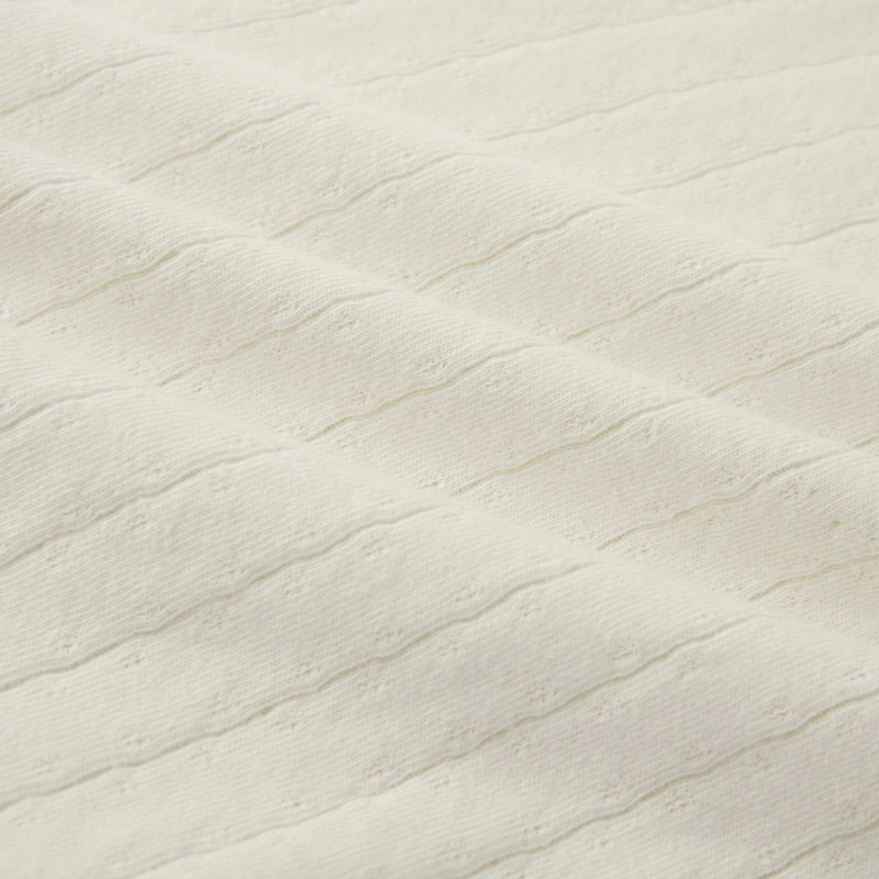 Baby wearing organic cotton plant-dyed unisex romper

