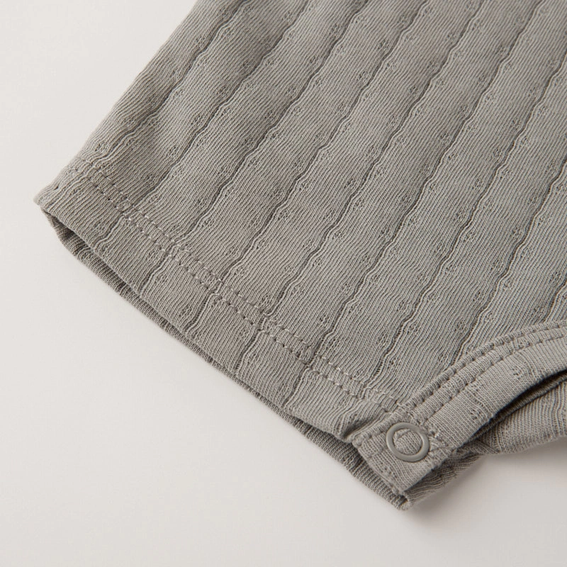 Baby wearing organic cotton plant-dyed unisex romper

