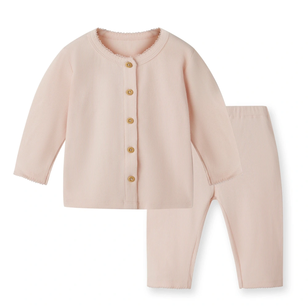 close up of front on girl long sleeve ribbed button-up top and pants set made from organic cotton with natural plant dyes