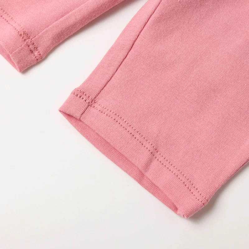 Close-up view of the cuffed ankles on the infant pants.