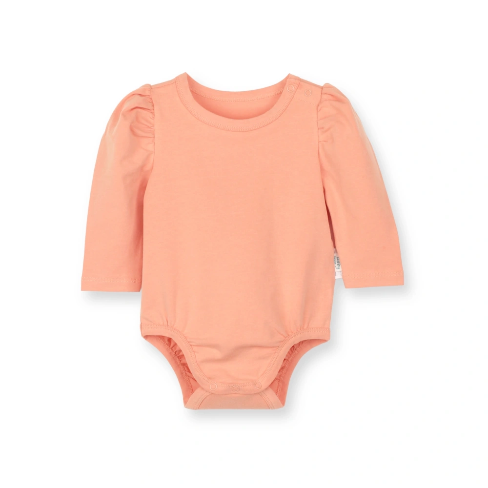 Front view of SENSENG baby girl gathered bubble sleeve long sleeve bodysuit in plant-dyed botanical natural coral colorway, showing expandable neckline.