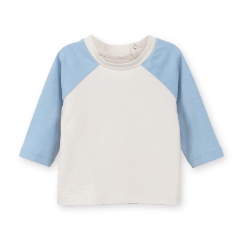 Front flat layout of the breathable organic cotton toddler raglan tee featuring plant-dyed natural powder puff and bonnie blue color blocking.