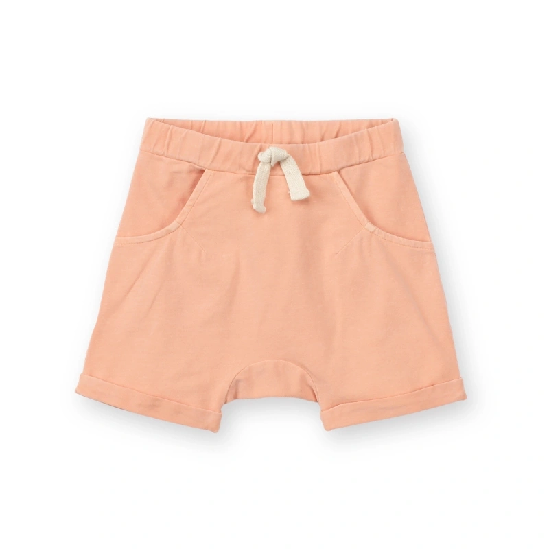 Picture of a baby girl wearing Senseng organic cotton baby knit jogger shorts with plant-dyed color