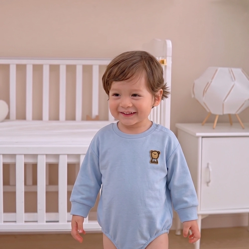 Baby Organic Cotton Plant-Dyed Long Sleeve Bodysuit in Serene Natural Baby Blue with Bear Embroidery, Shoulder Snaps, and Bottom Placket.
