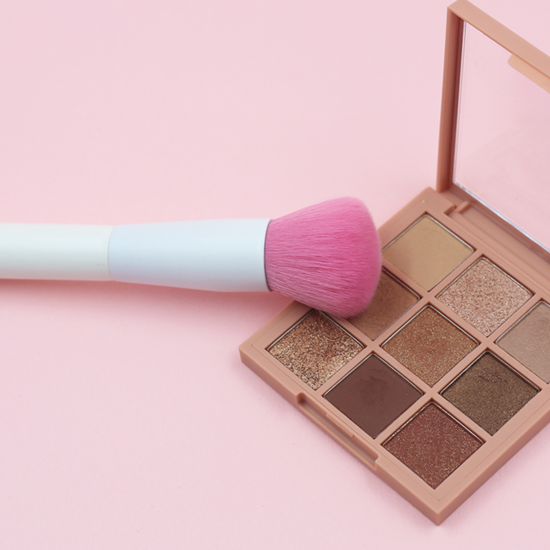 Blush brush with pink nylon hair and pure white handle