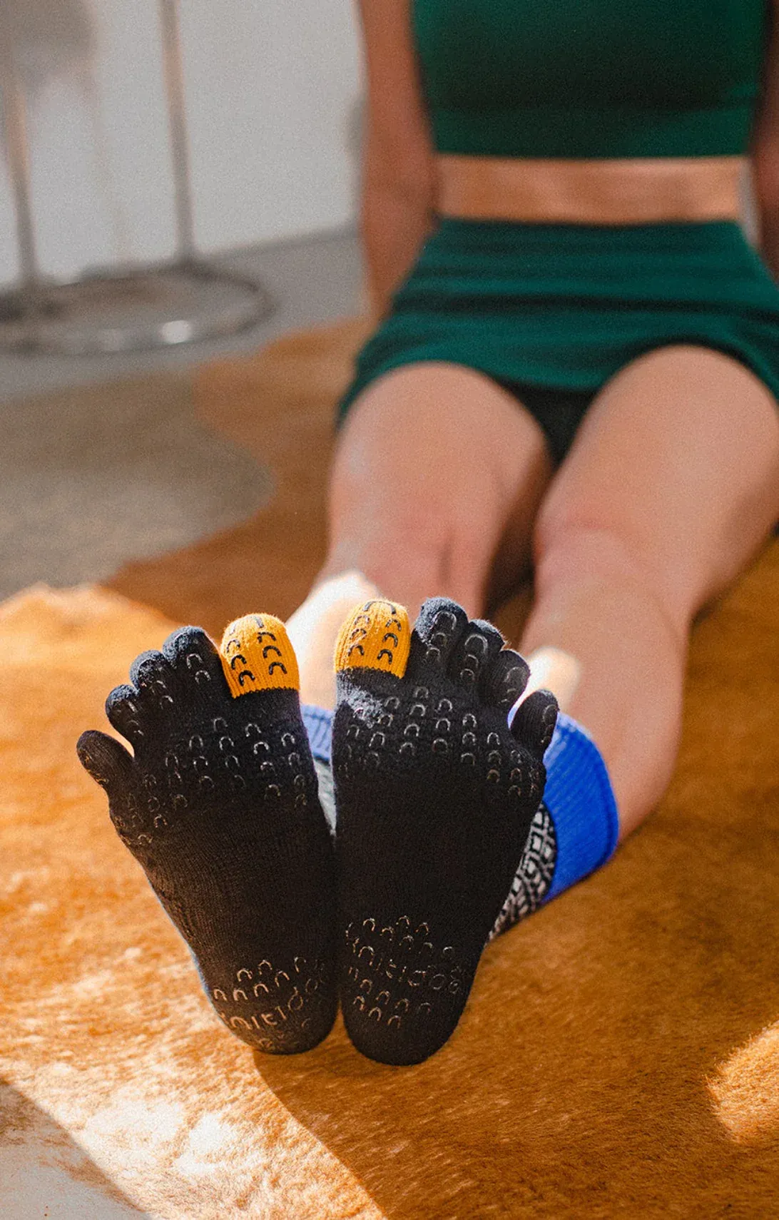 Multicolor grip socks with toe separation and silicone traction elements, designed to enhance stability during balance exercises