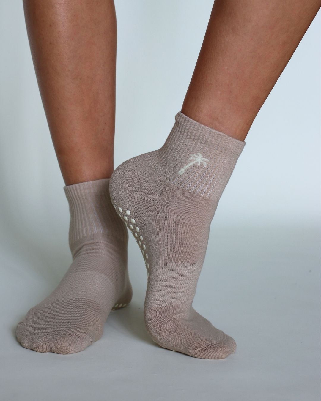 Ankle-length grip socks showing grip dot placement and fabric condition for maintenance inspection