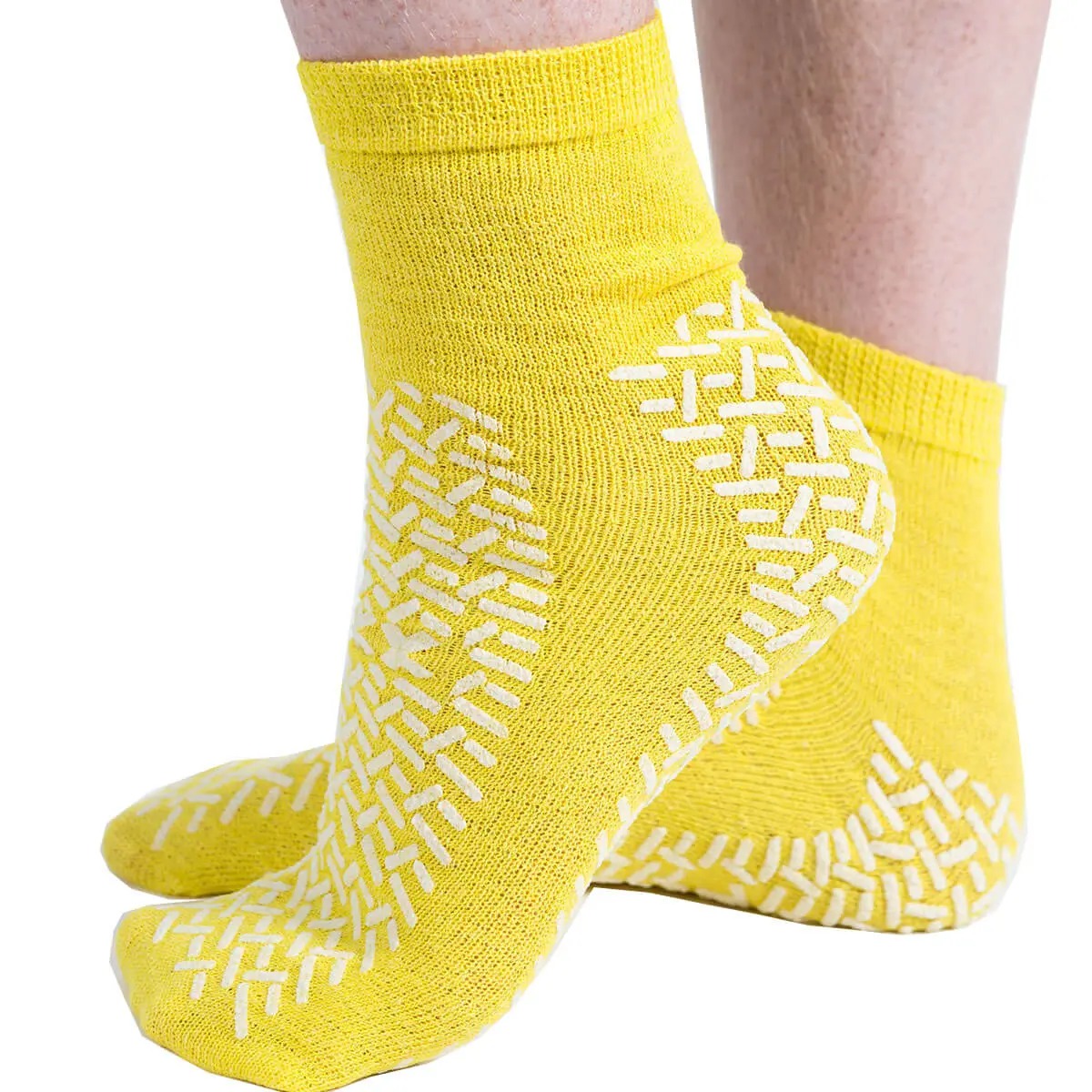 Non-slip grip socks with distributed silicone patterns covering the sole and heel area