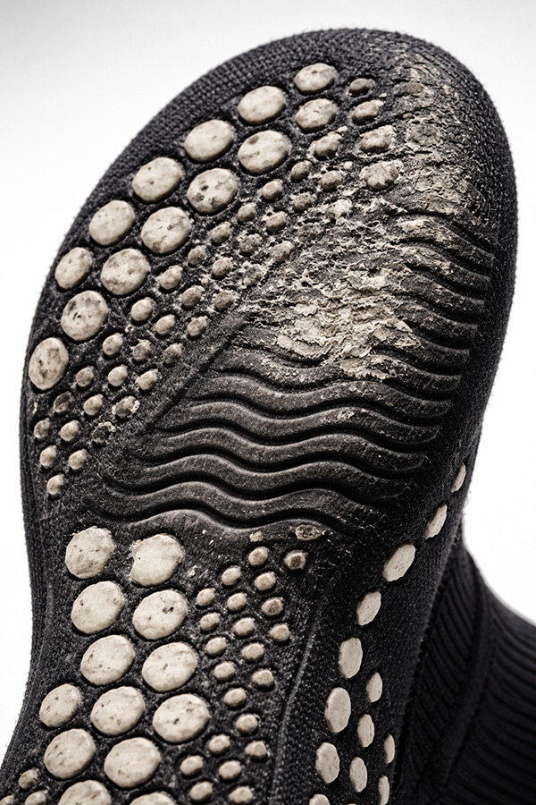 Wear patterns on grip sock soles showing changes in durability over time