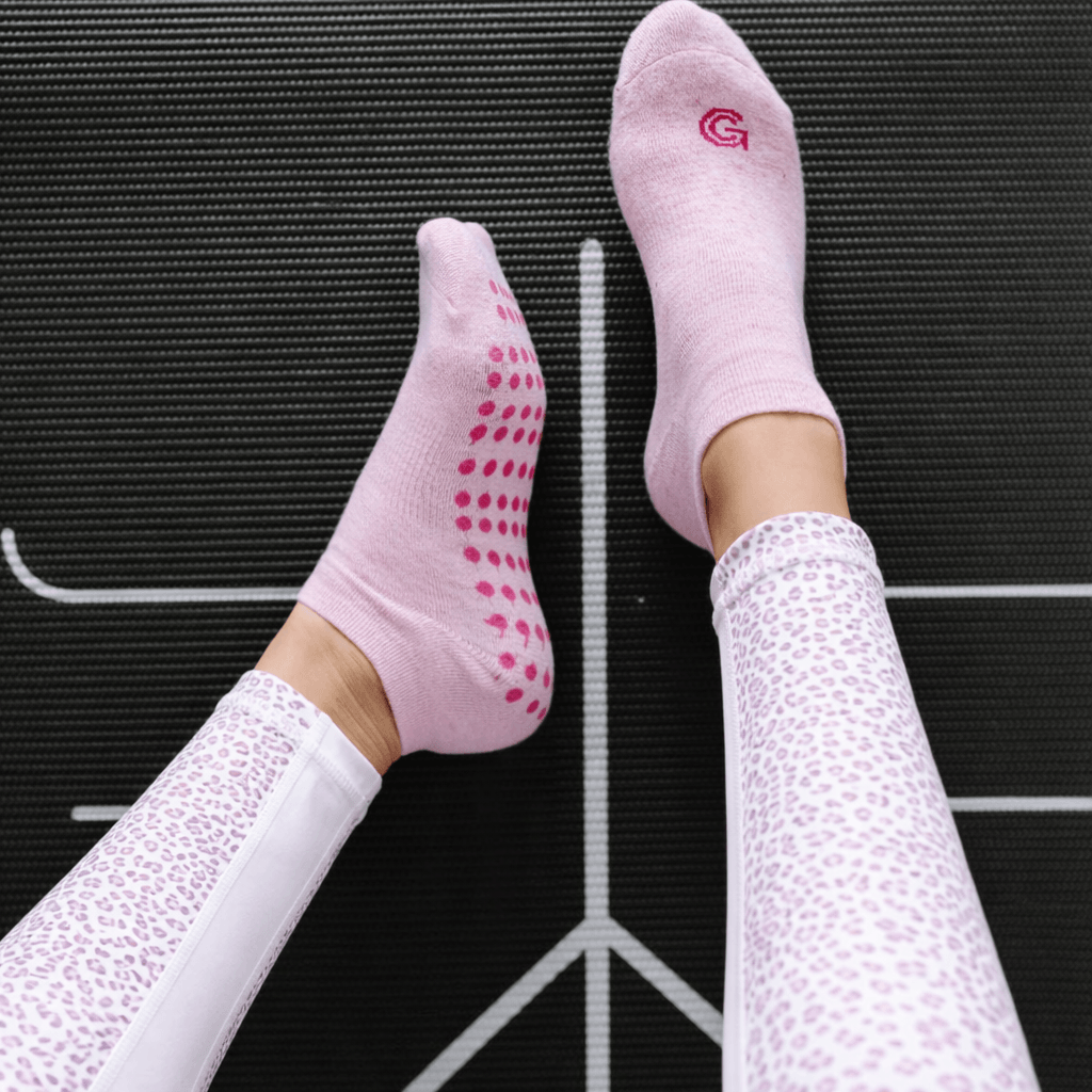 logo grip socks worn on yoga mat, custom logo grip socks for fitness training, branded grip socks designed for yoga and pilates studios