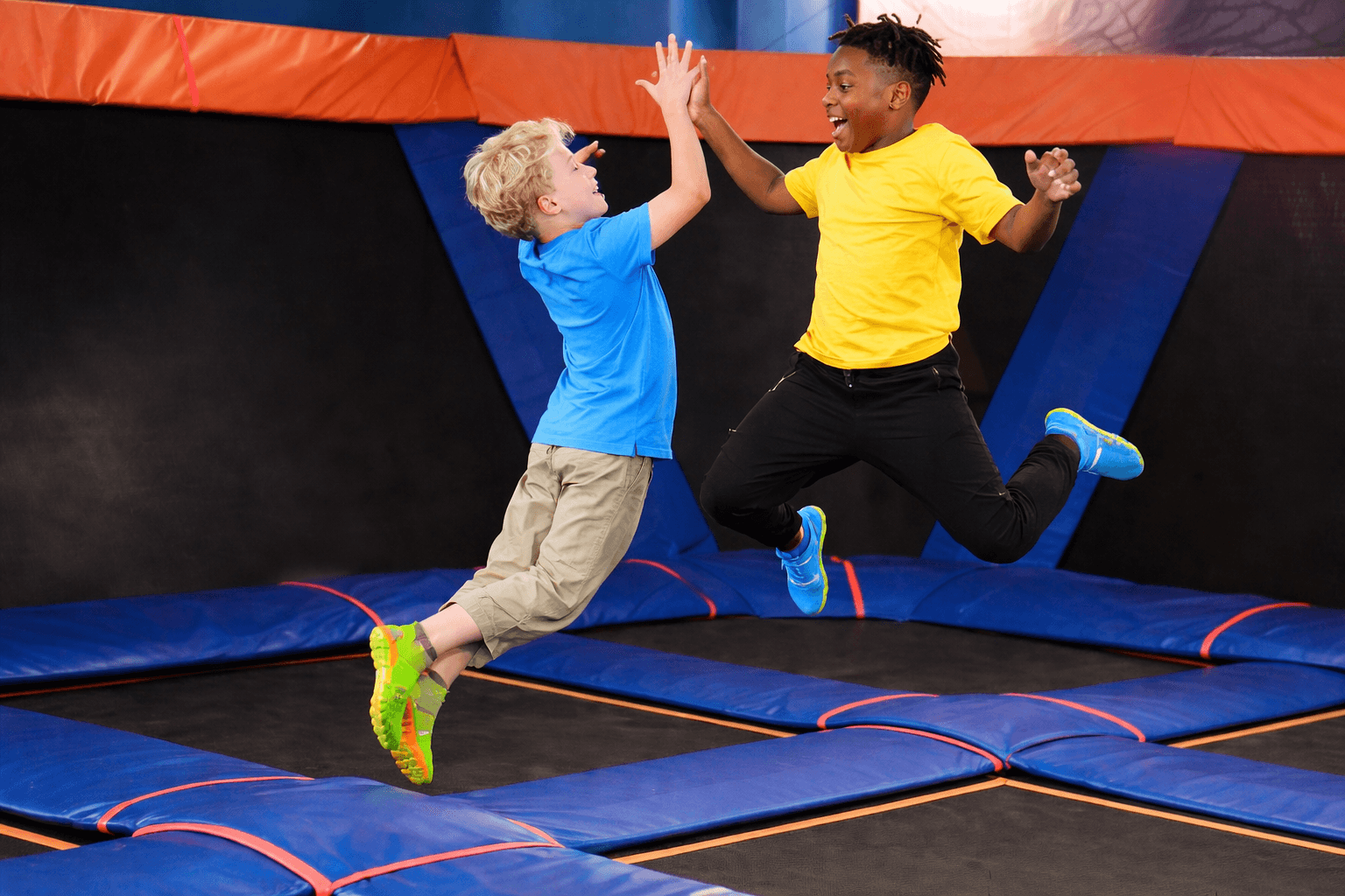 children wearing trampoline park socks custom with non slip soles, custom trampoline socks for indoor play areas and trampoline grip socks OEM supply