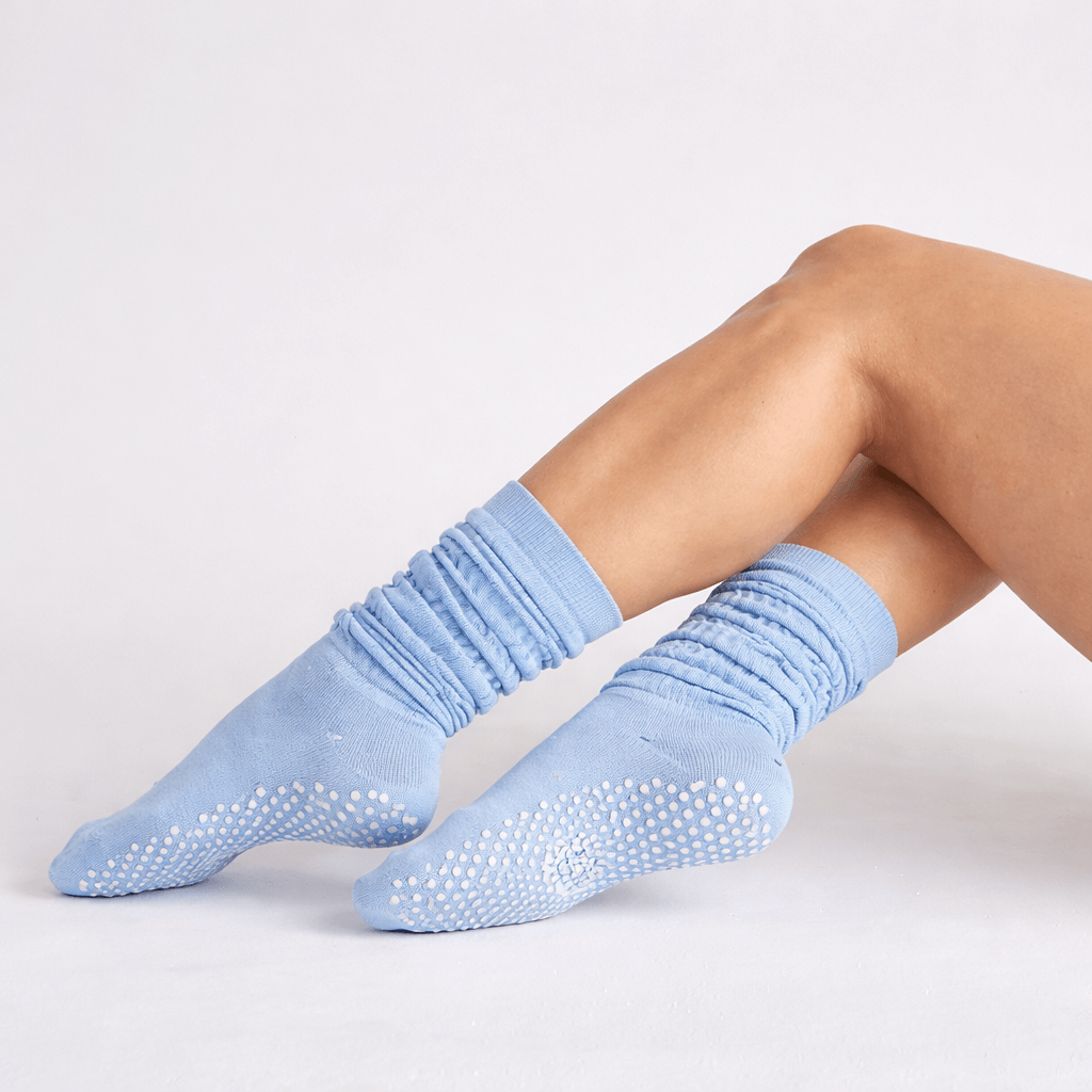 blue pilates grip socks with slouch style and non slip sole grip pattern close up