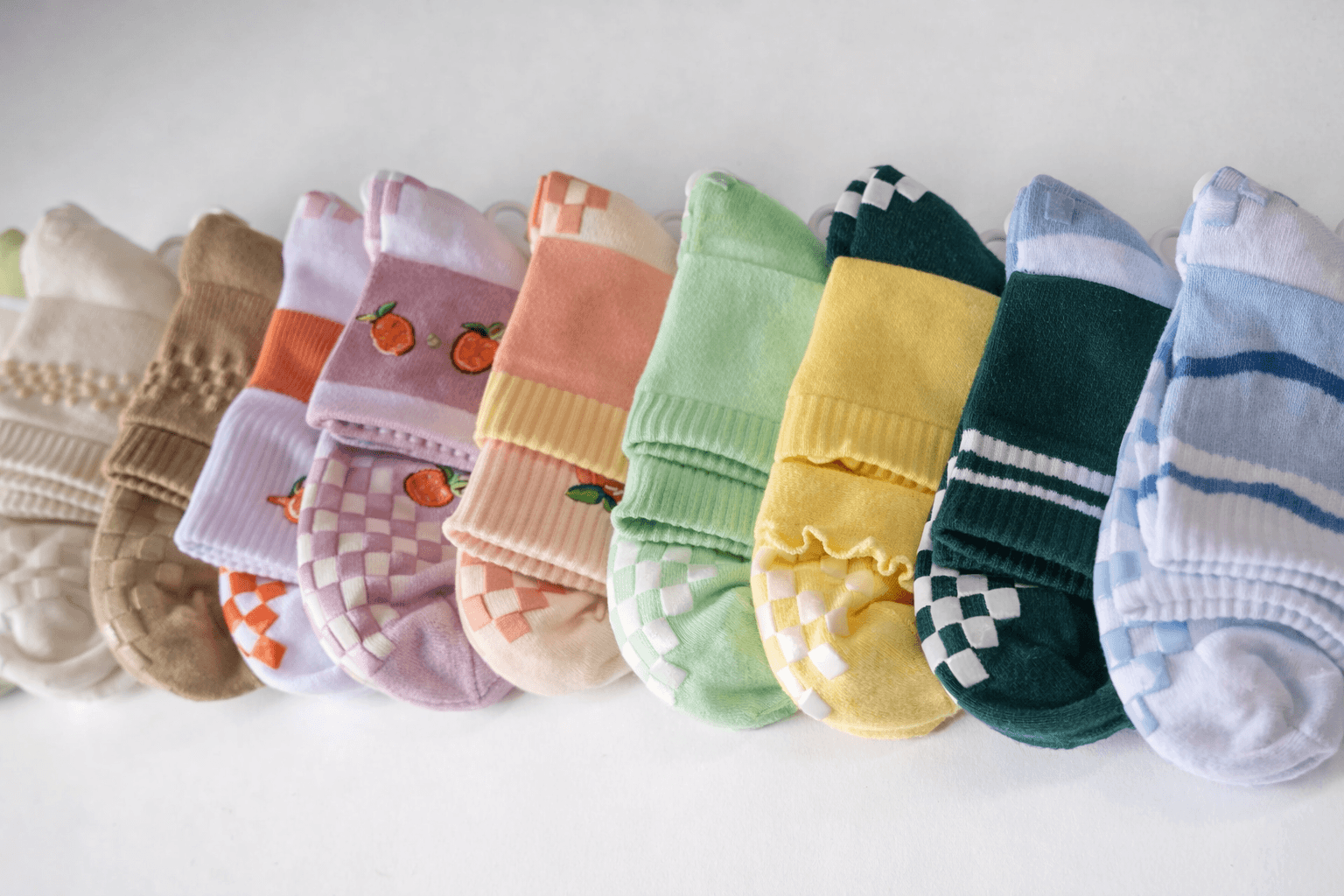 Grip socks bulk supplier display featuring colorful anti slip socks wholesale collection for trampoline parks and fitness use