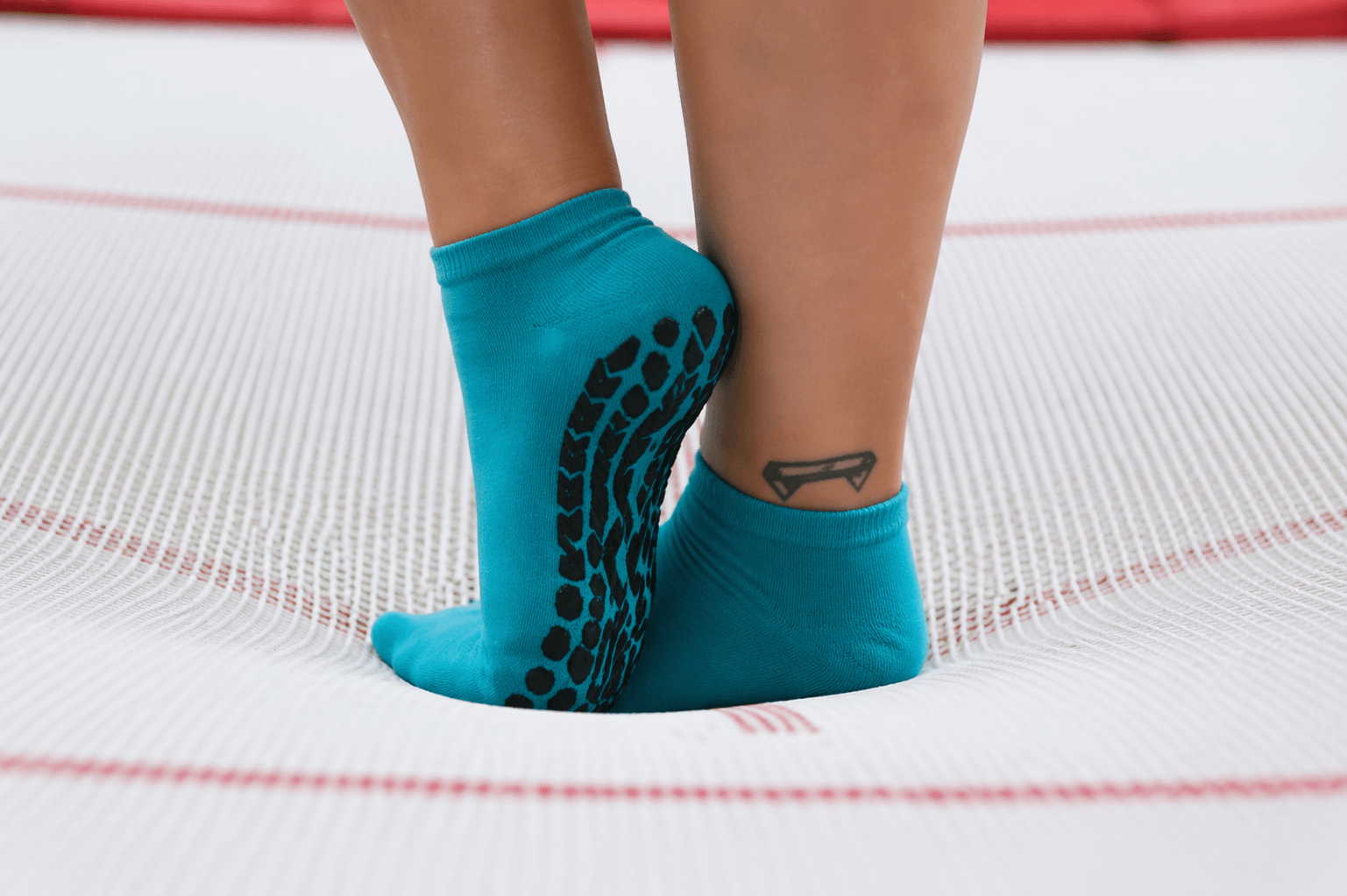 trampoline socks vs regular socks comparison showing grip pattern vs normal socks on trampoline surface