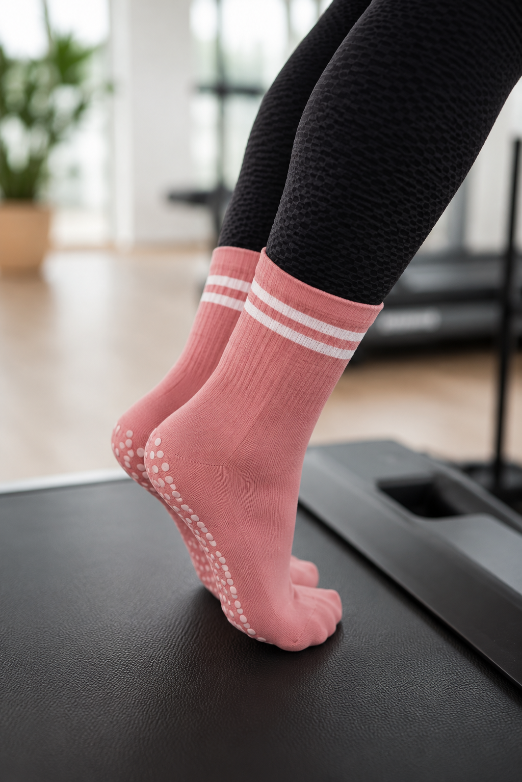 pink best grip socks for barre training with non slip grip sole on reformer and fitness equipment