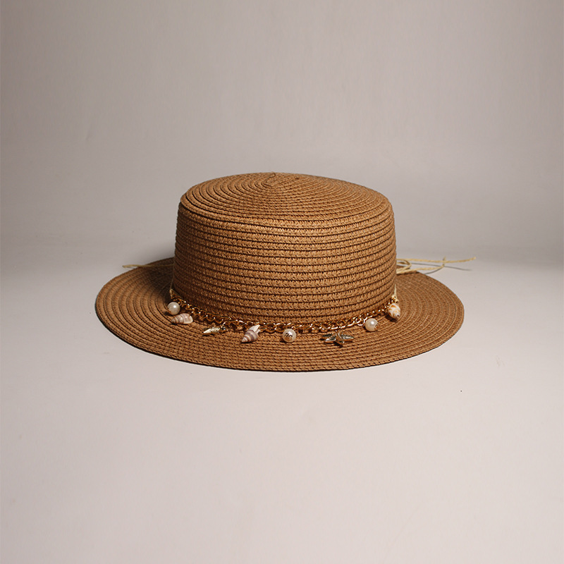New style round-top straw hat with polka dot ribbon and pearl trim, perfect for beach outings.