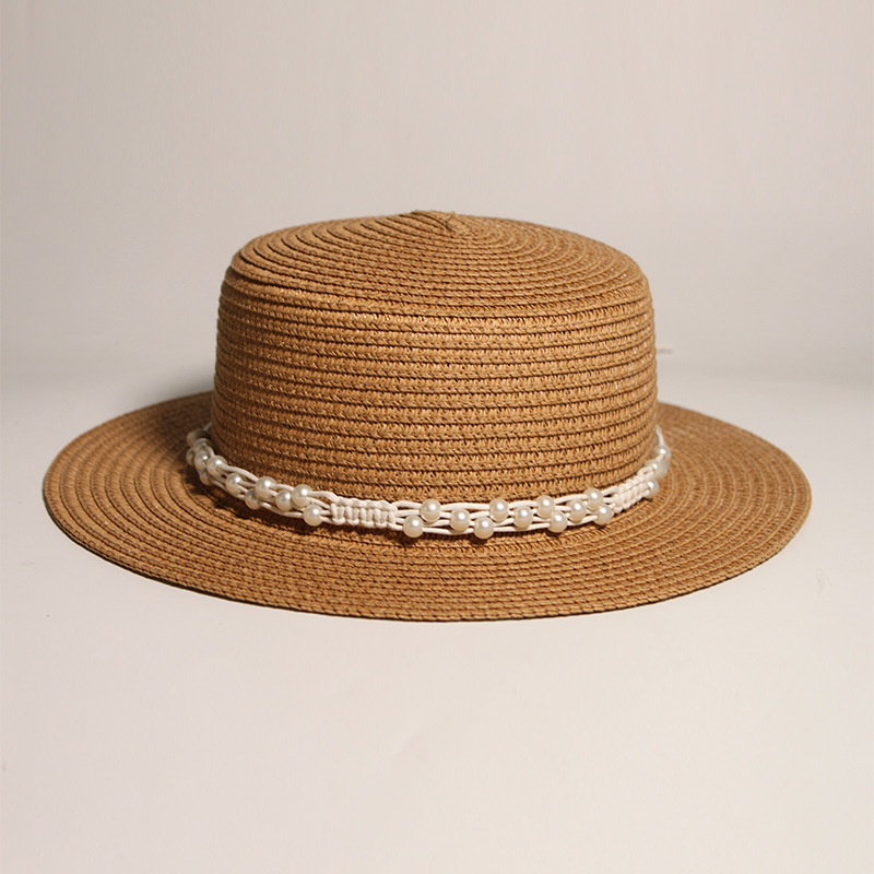 New style round-top straw hat with polka dot ribbon and pearl trim, perfect for beach outings.