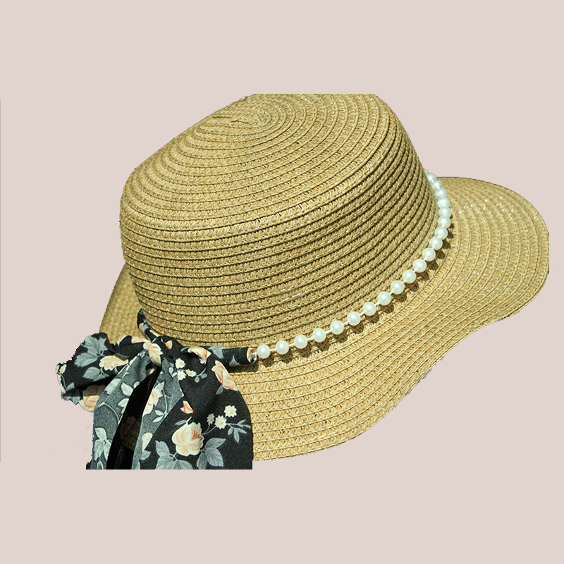 New style round-top straw hat with polka dot ribbon and pearl trim, perfect for beach outings.