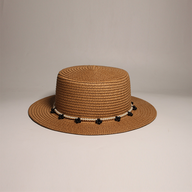 New style round-top straw hat with polka dot ribbon and pearl trim, perfect for beach outings.